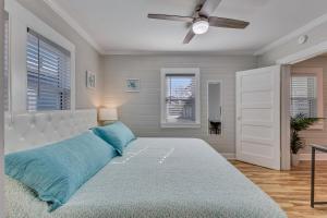 una camera da letto con un letto grande e un ventilatore a soffitto di Harper Haven by Carolina Beach Realty a Carolina Beach
