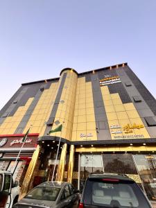 a building with cars parked in front of it at مكارم العرب للشقق المخدومة in Sakakah