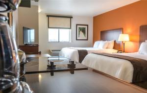 a hotel room with two beds and a table at My Place Hotel-Lubbock, TX in Lubbock