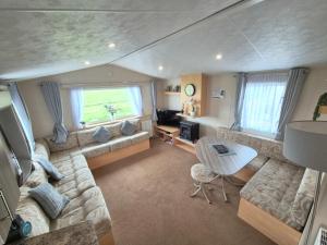 a living room with a couch and a table at Whitstable Vacation in Kent