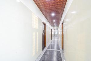 an empty corridor of a building with a wooden ceiling at Super Townhouse Kokapet Formerly Aarian Tej Nilayam in Hyderabad +55 photos