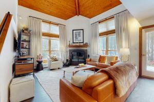 a living room with a couch and a fireplace at Trail Creek 72 in Killington