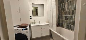 a bathroom with a washing machine and a sink at House of the Sun in Ventspils +16 photos