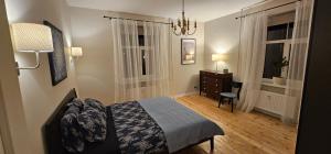 a bedroom with a bed and a desk and a window at House of the Sun in Ventspils