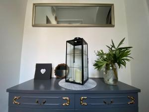 a blue dresser with a glass jar on top of it at Flow - City Centre Zadar in Zadar