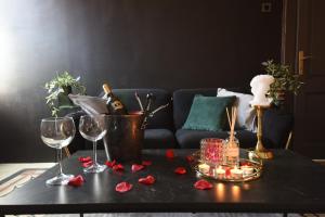 a table with wine glasses and roses on it at Flow - City Centre Zadar in Zadar