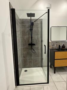 a shower with a glass door in a bathroom at A la ferme - Colline Beaumont in Colline-Beaumont +14 photos