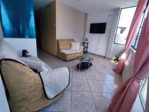 a living room with a couch and a chair at My house is your house in Manta