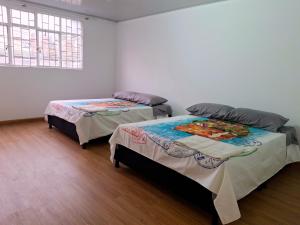 a room with two beds in a room at Casa Bella Vista in Bogotá