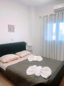 a bedroom with a bed with two towels on it at MariAggela's Cosy House in Theologos
