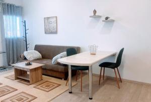 a living room with a table and a couch at MariAggela's Cosy House in Theologos +2 photos
