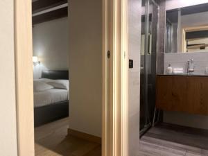 Un baño con lavabo y un dormitorio con cama. en Casa Gemmas Daydream, en Burano