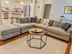 a living room with a couch and a table at Serene Retreat House and Tiny house for 11 in Roswell