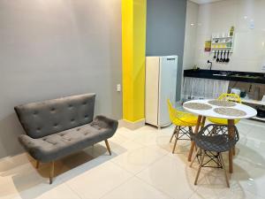 a kitchen with a table and a chair and a dining room at Loft com ar condicionado in Goiânia