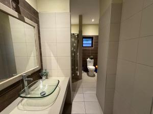 a bathroom with a sink and a toilet at Seaview Oasis in Gated Community and Walk to Beaches in Willemstad