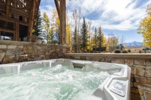 a jacuzzi tub in the backyard of a house at Mountain House by Exceptional Stays in Telluride +23 photos