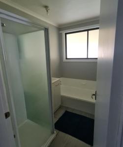 a bathroom with a shower and a bath tub at Zeehan 3 bedroom house in Zeehan