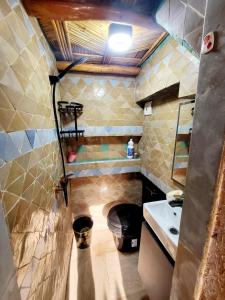a small bathroom with a sink and a toilet at Duplex Reposant avec piscine au Andalines Golf Royal Fès in Dar Ito Lahssene