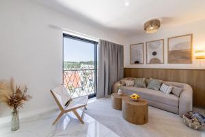 a living room with a couch and a table at Cocco & Limone Boutique Residence in Sutivan