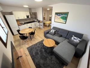 a living room with a couch and a table and a kitchen at Casa Bertolo in Radiquero