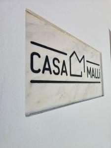 a sign on a wall with the name of a mall at CasaMalli in Selmes
