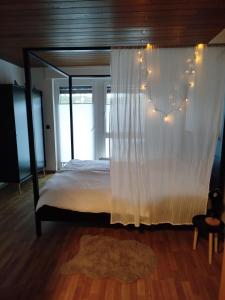 a bedroom with a canopy bed with string lights at Ferienwohnung Zur goldenen Glocke in Mechernich