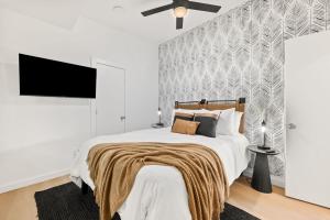 a bedroom with a large bed with a wall at New-Dog Friendly,Hot Tub, Fire-pit, 1 mile to DTWN in Saint Augustine