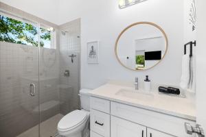 a white bathroom with a shower and a sink and a mirror at New-Dog Friendly,Hot Tub, Fire-pit, 1 mile to DTWN in Saint Augustine +53 photos