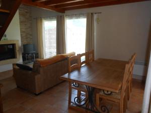 a living room with a table and a couch at Domaine Harrieta in Saint-Jean-le-Vieux