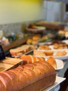 a bunch of loaves of bread on plates on a counter at Barueri Premiêr Hotel in Barueri