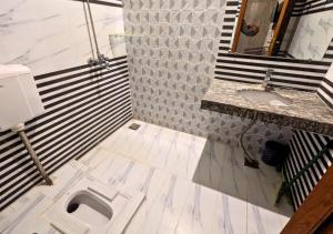a bathroom with a toilet and a sink at Doveinn Hotel R1 in Lahore +38 photos