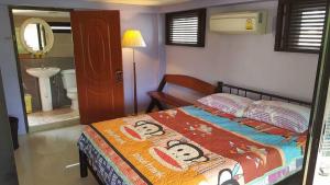 a bedroom with a bed and a bathroom at Kaengkrachan River Hut in Kaeng Krachan +171 photos