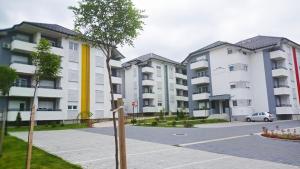 a row of apartment buildings in a parking lot at COMODO "Green Hill" in Soko Banja