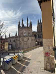 a large building with several trash cans in front of it at VISTA GÓTICA CATEDRAL BURGOS Spain in Burgos