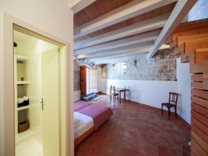 a bedroom with a bed and a table in a room at Authentic Stone House Kut in Vis
