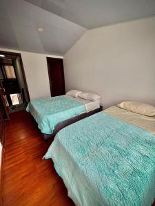 Postel nebo postele na pokoji v ubytování Kuyay Yachi Hostel