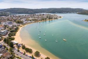an aerial view of a beach with boats in the water at Cute Coastal 2-Bedroom Getaway in Ettalong Beach
