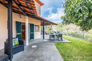 a patio of a house with a table and chairs at Sea View Villa by Homie in Santa Cruz