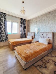 Ένα ή περισσότερα κρεβάτια σε δωμάτιο στο Ailes du vent, coucher de soleil,vue sur mer