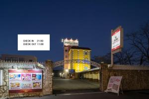 a yellow building with a sign in front of it at アンジェリーククロッシュ 男塾ホテルグループ in Himeji +11 photos