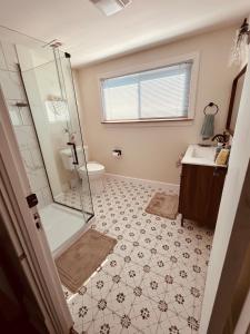 a bathroom with a shower and a toilet and a sink at Paisley Garden House Near Kings Daughters Hospital in Ashland +33 photos