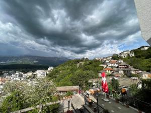 a view of a town on a hill under a cloudy sky at Villa Çabeli in Gjirokastër