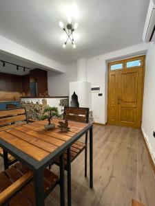 a dining room with a table and a living room at Villa Çabeli in Gjirokastër