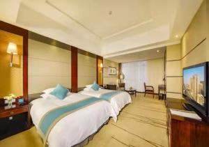 TV a/nebo společenská místnost v ubytování Gaosu New Century Hotel International Anhui