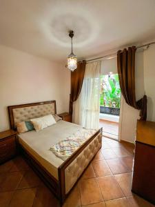 a bedroom with a bed and a large window at Visit Chamal - Oualya in Oued Laou +14 photos