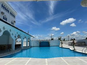 a swimming pool on the side of a building at Hotel Palace in La Concordia