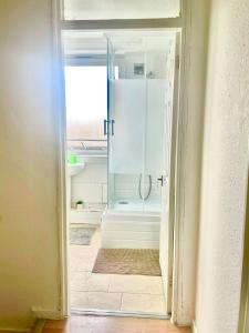 a bathroom with a shower and a glass door at Harolds Home in London +85 photos