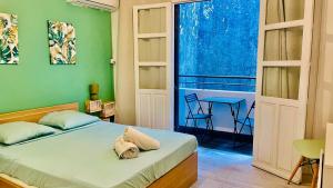 a bedroom with a bed and a table and a window at Appart' Del Sol in Pointe-à-Pitre