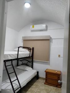 a room with two bunk beds and a mirror at Hermosa Casa Con Alberca AC in Ixtapa +31 photos