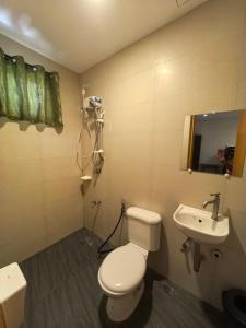 a bathroom with a toilet and a sink at Espacio de Clarita Hometel in Davao City +12 photos